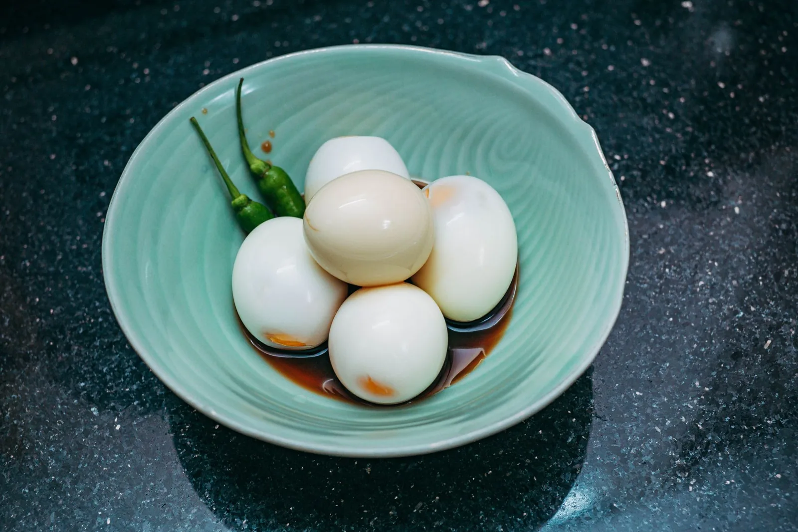 Peeled hard-boiled eggs in a bowl — the fully cooked form egg takes when it first enters a baby's food